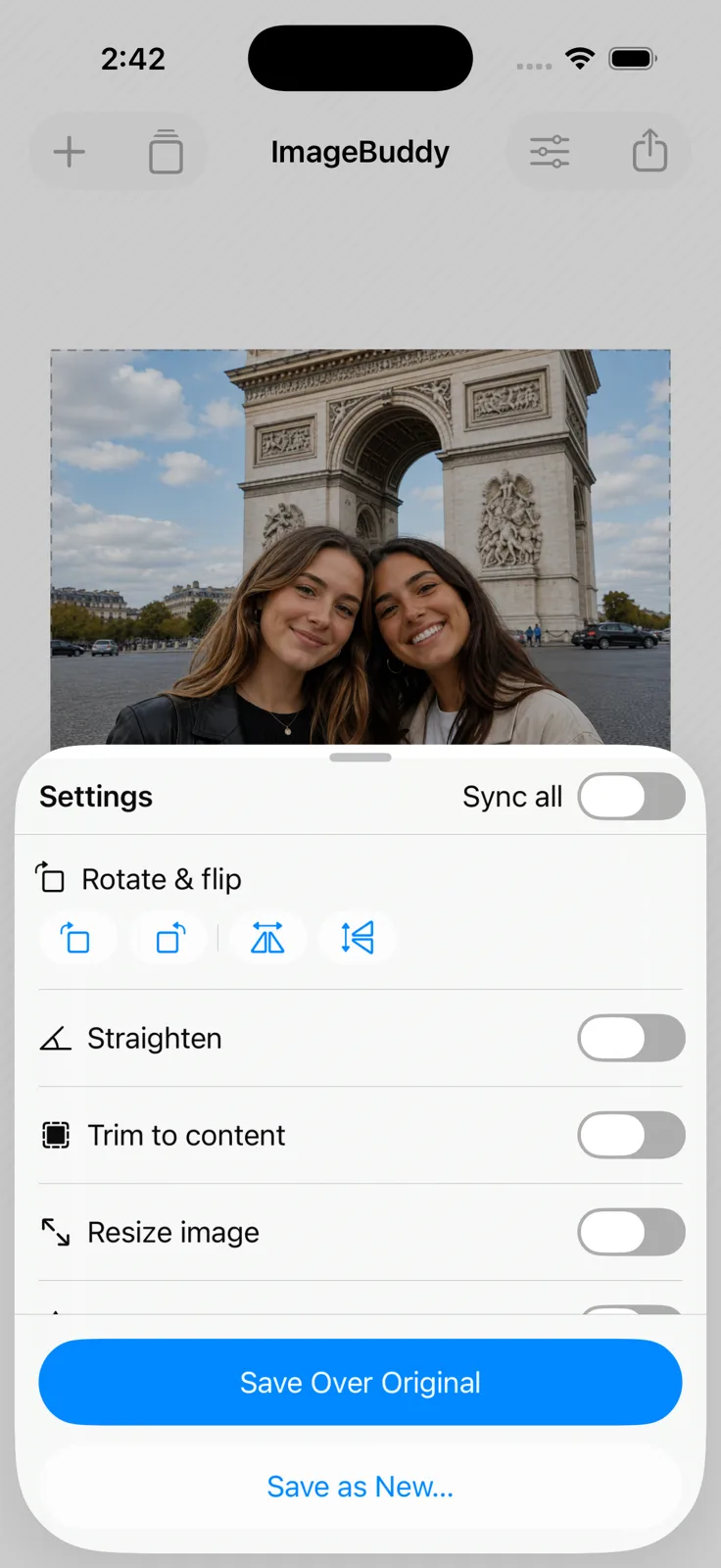 ImageBuddy on iPhone — a photo filling the screen above a half-height Settings sheet carrying Rotate & flip, Straighten and Trim to content