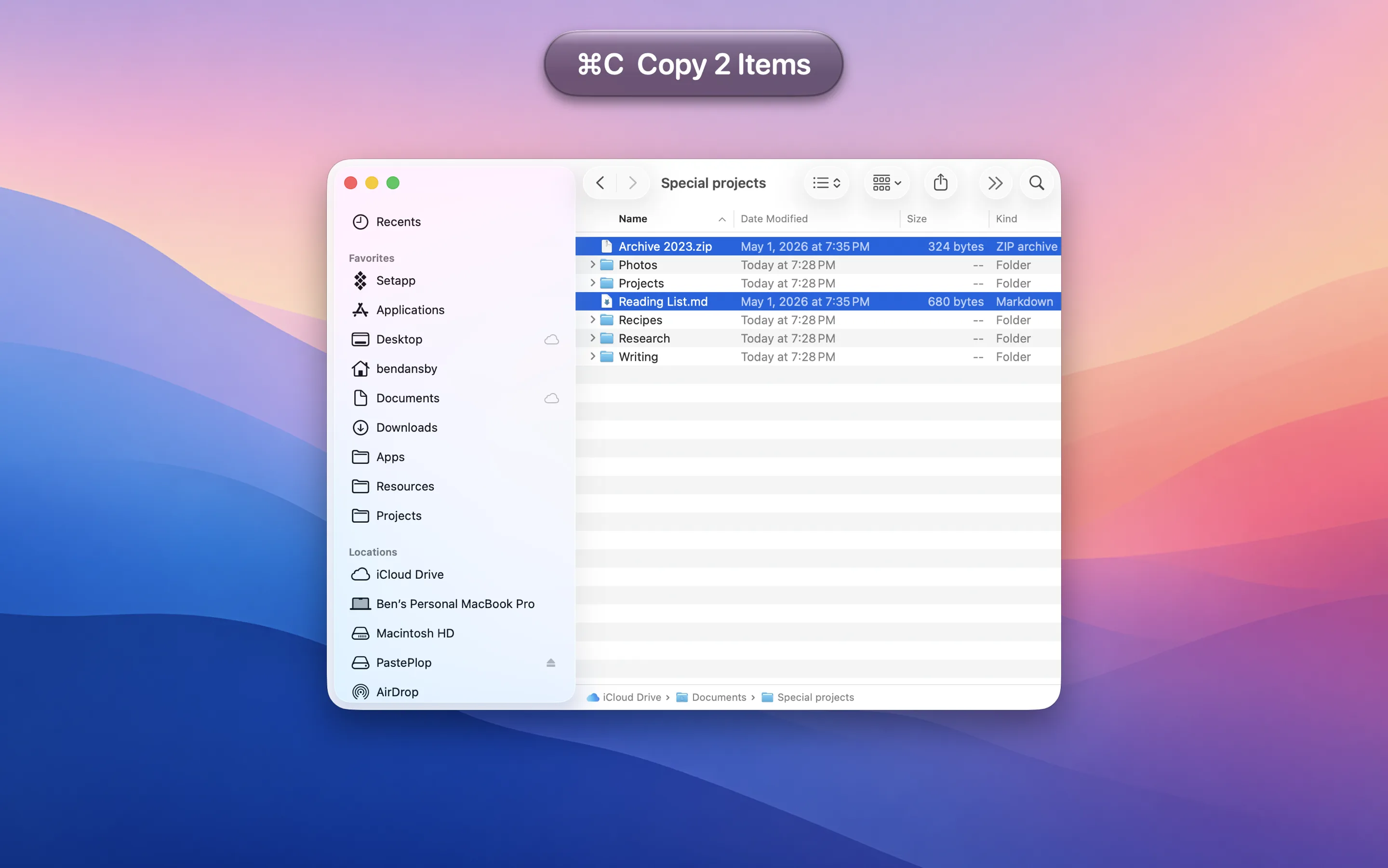 KeyStruck HUD overlay reading ⌘C Copy 2 Items above a Finder window