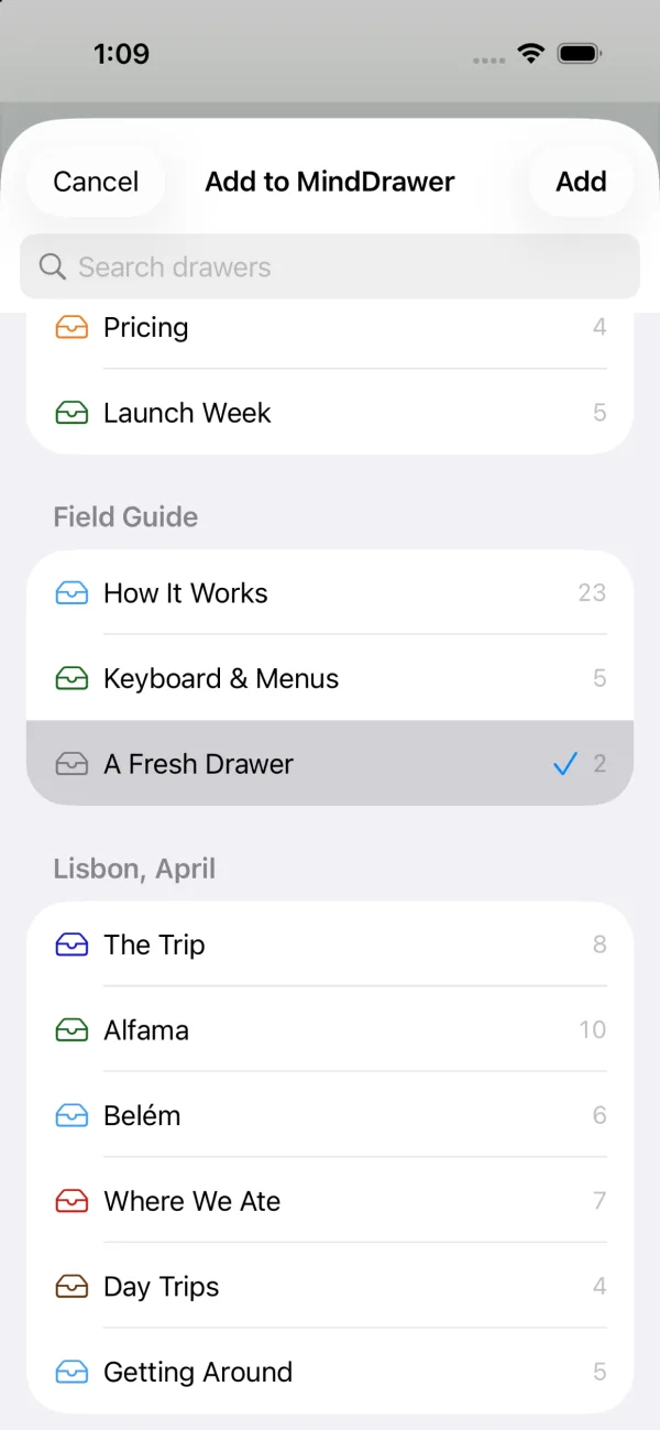Sharing something to MindDrawer on iPhone — a sheet headed Add to MindDrawer listing every drawer grouped by cabinet, with one ticked